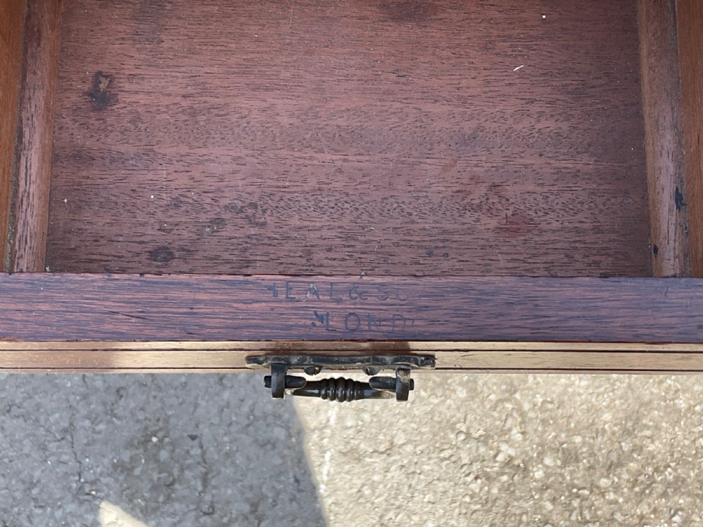 An Edwardian walnut kneehole writing desk with a leather inset top, brass ring handles, turned legs, and a raised drawer gallery. View IX