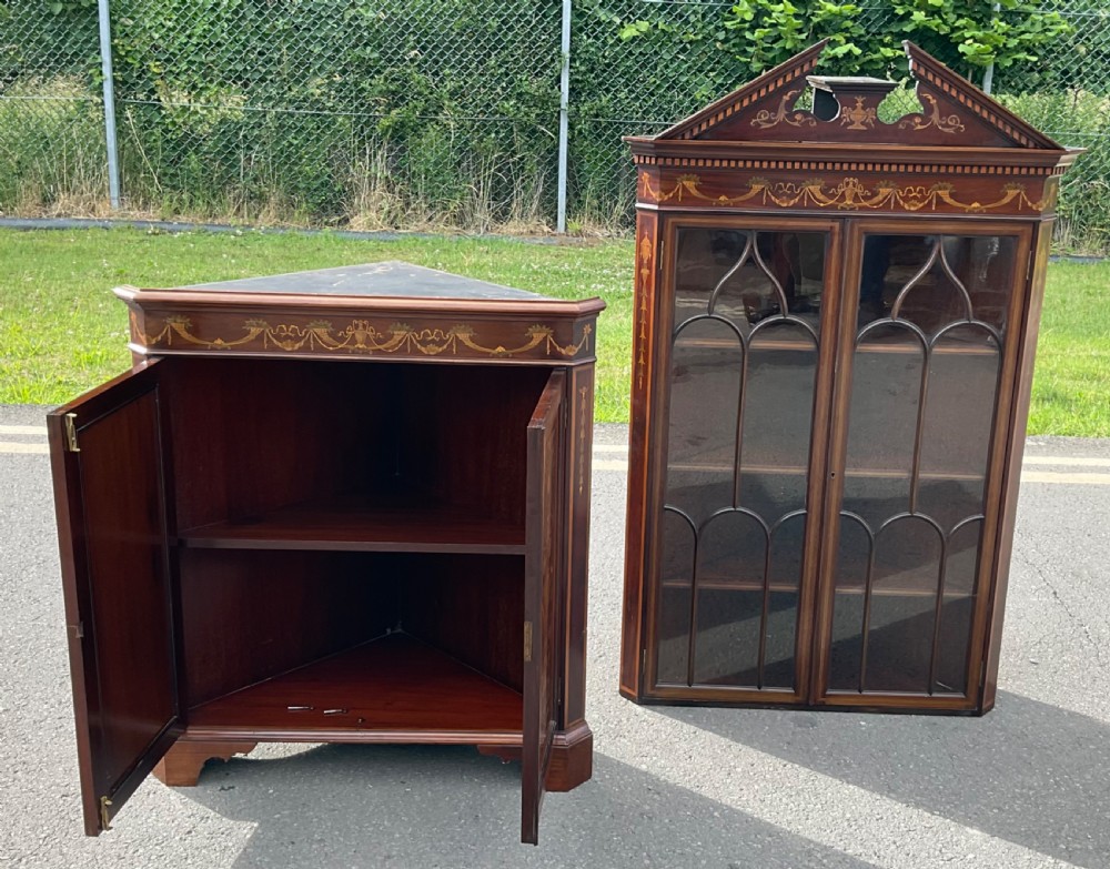 An Edwardian inlaid mahogany standing corner cabinet featuring a broken pediment, astragal glazed upper doors, and marquetry inlaid lower panels. View XIII