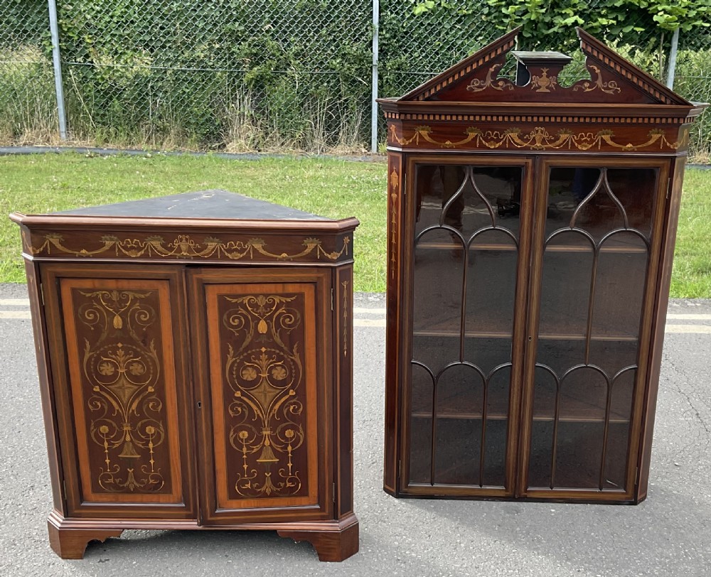 An Edwardian inlaid mahogany standing corner cabinet featuring a broken pediment, astragal glazed upper doors, and marquetry inlaid lower panels. View XIV