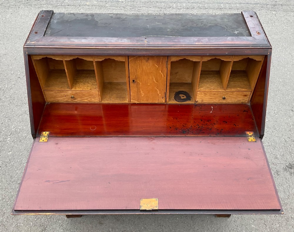An Edwardian inlaid mahogany bureau bookcase featuring a two-door astragal glazed upper cabinet above a fall-front writing desk and four long drawers. View XI