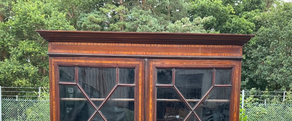 An Edwardian inlaid mahogany bureau bookcase featuring a two-door astragal glazed upper cabinet above a fall-front writing desk and four long drawers. View XIII