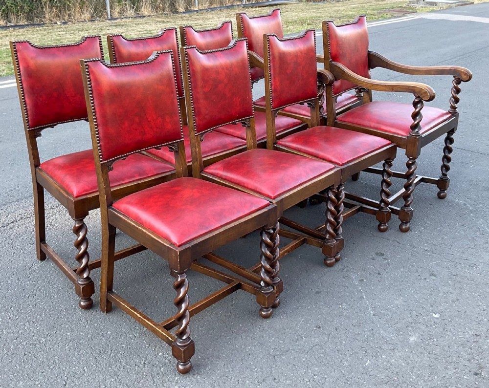 A set of eight oak dining chairs featuring red leather upholstery with brass stud detailing and spiral barley twist legs. View III