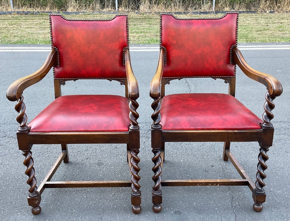 A set of eight oak dining chairs featuring red leather upholstery with brass stud detailing and spiral barley twist legs. View VII