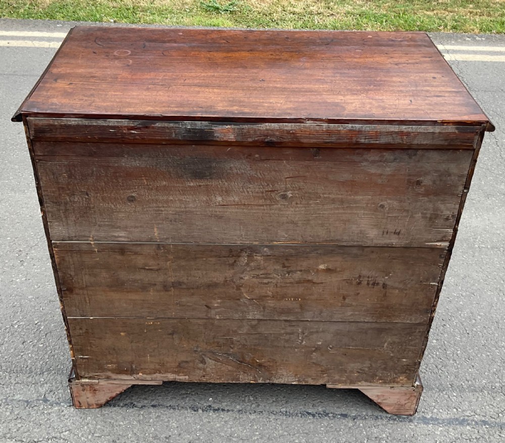 A Georgian mahogany chest of drawers featuring a two short over three long drawer arrangement with brass handles and bracket feet. View XIII