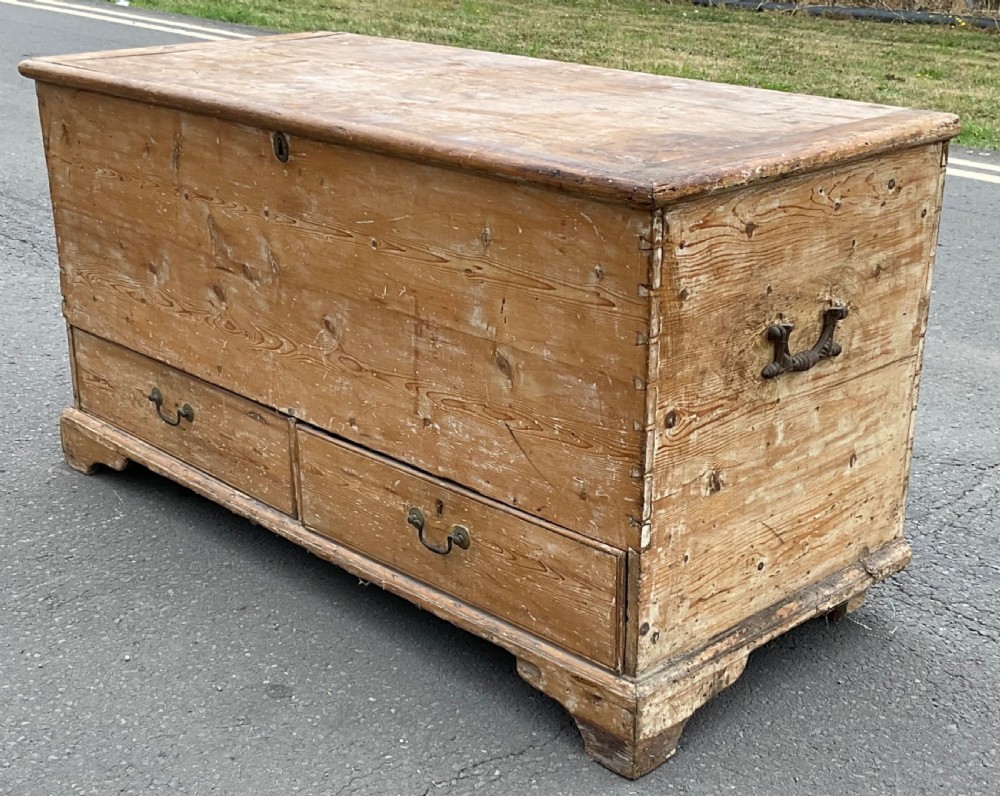 A large Georgian pine mule chest featuring a lift-top storage section above two lower drawers with brass drop handles and bracket feet. View III