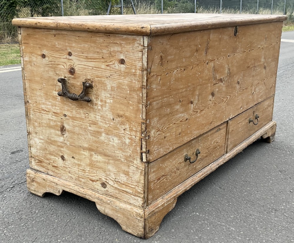 A large Georgian pine mule chest featuring a lift-top storage section above two lower drawers with brass drop handles and bracket feet. View VI