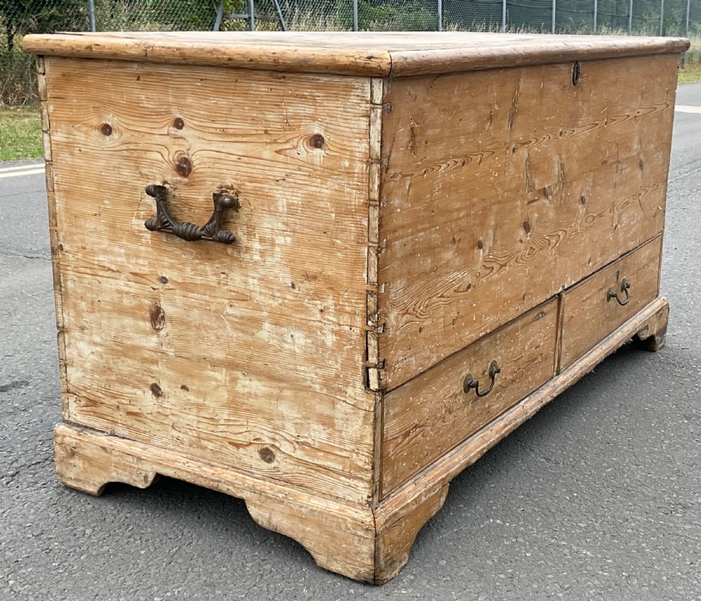 A large Georgian pine mule chest featuring a lift-top storage section above two lower drawers with brass drop handles and bracket feet. View VII