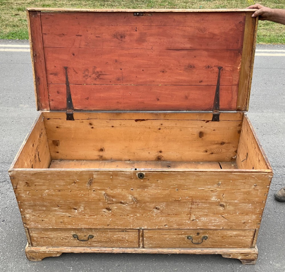A large Georgian pine mule chest featuring a lift-top storage section above two lower drawers with brass drop handles and bracket feet. View IX