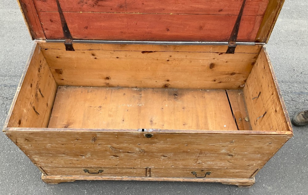 A large Georgian pine mule chest featuring a lift-top storage section above two lower drawers with brass drop handles and bracket feet. View X