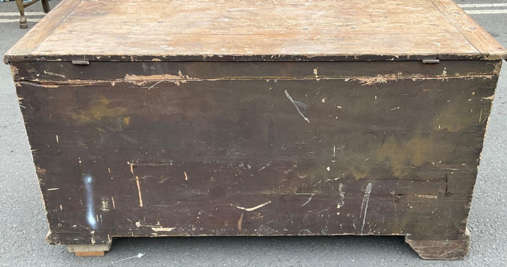 A large Georgian pine mule chest featuring a lift-top storage section above two lower drawers with brass drop handles and bracket feet. View XI