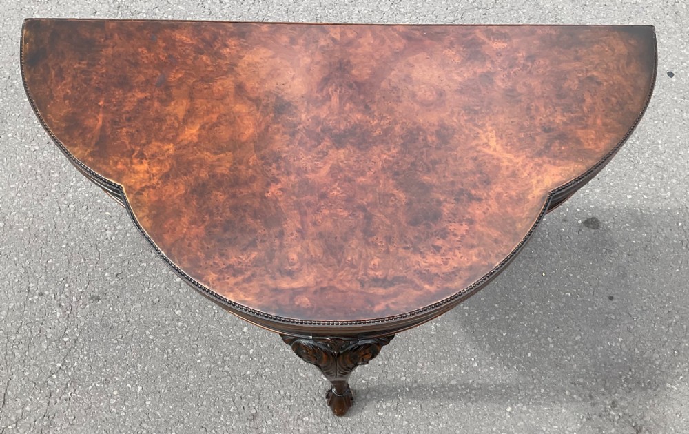 A Queen Anne style walnut foldover card table featuring a shaped top, carved cabriole legs, and claw and ball feet. View IV