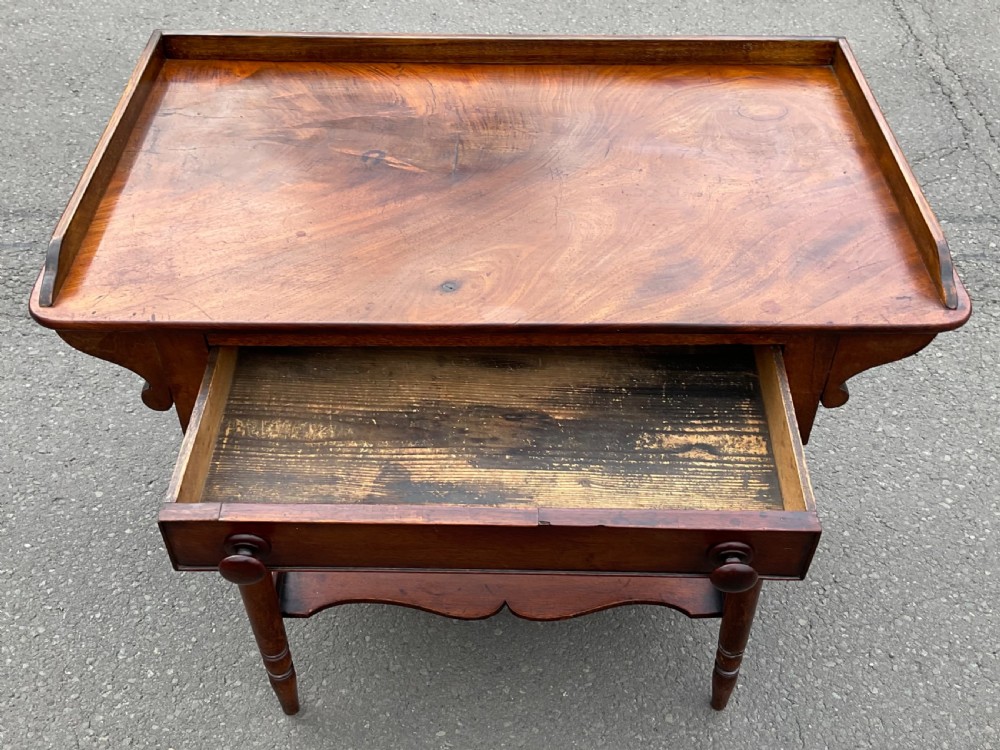 A Victorian mahogany side table featuring a galleried top, single drawer with wooden knobs, turned legs, and a scalloped lower shelf. View III