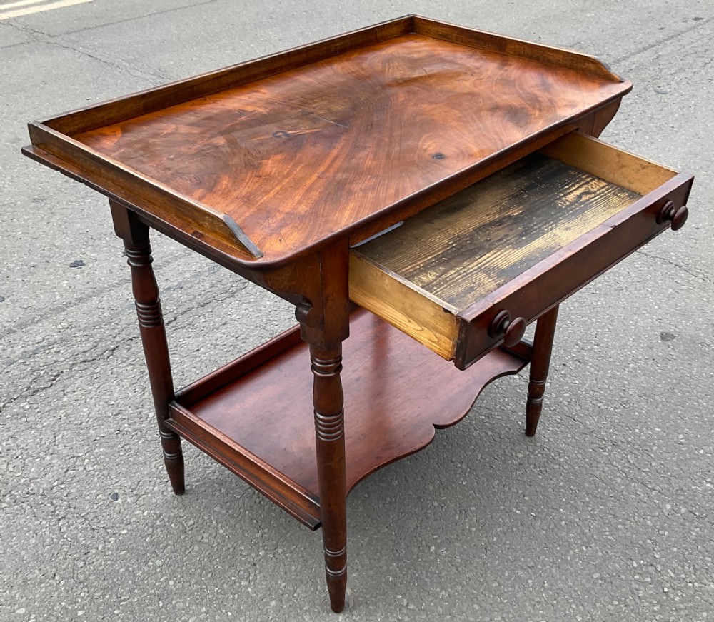 A Victorian mahogany side table featuring a galleried top, single drawer with wooden knobs, turned legs, and a scalloped lower shelf. View IV