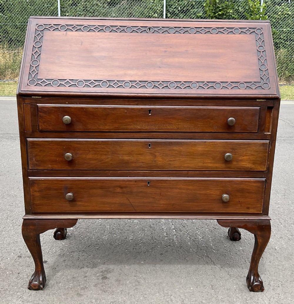A Chippendale style mahogany bureau bookcase featuring upper glazed doors, a slant-front writing slope, three drawers, and cabriole legs with ball and claw feet. View II
