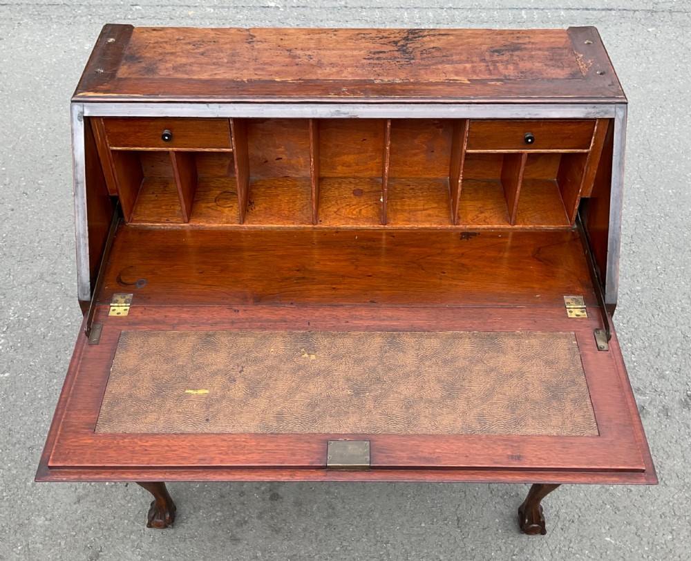A Chippendale style mahogany bureau bookcase featuring upper glazed doors, a slant-front writing slope, three drawers, and cabriole legs with ball and claw feet. View VIII