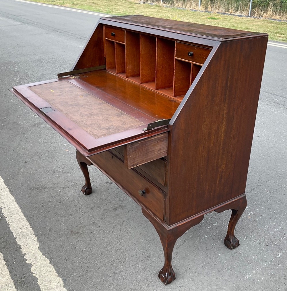 A Chippendale style mahogany bureau bookcase featuring upper glazed doors, a slant-front writing slope, three drawers, and cabriole legs with ball and claw feet. View IX