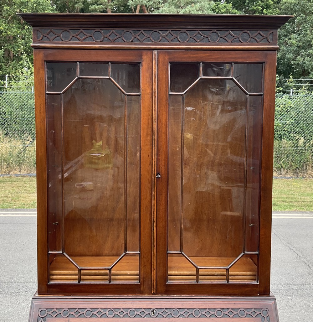 A Chippendale style mahogany bureau bookcase featuring upper glazed doors, a slant-front writing slope, three drawers, and cabriole legs with ball and claw feet. View XI