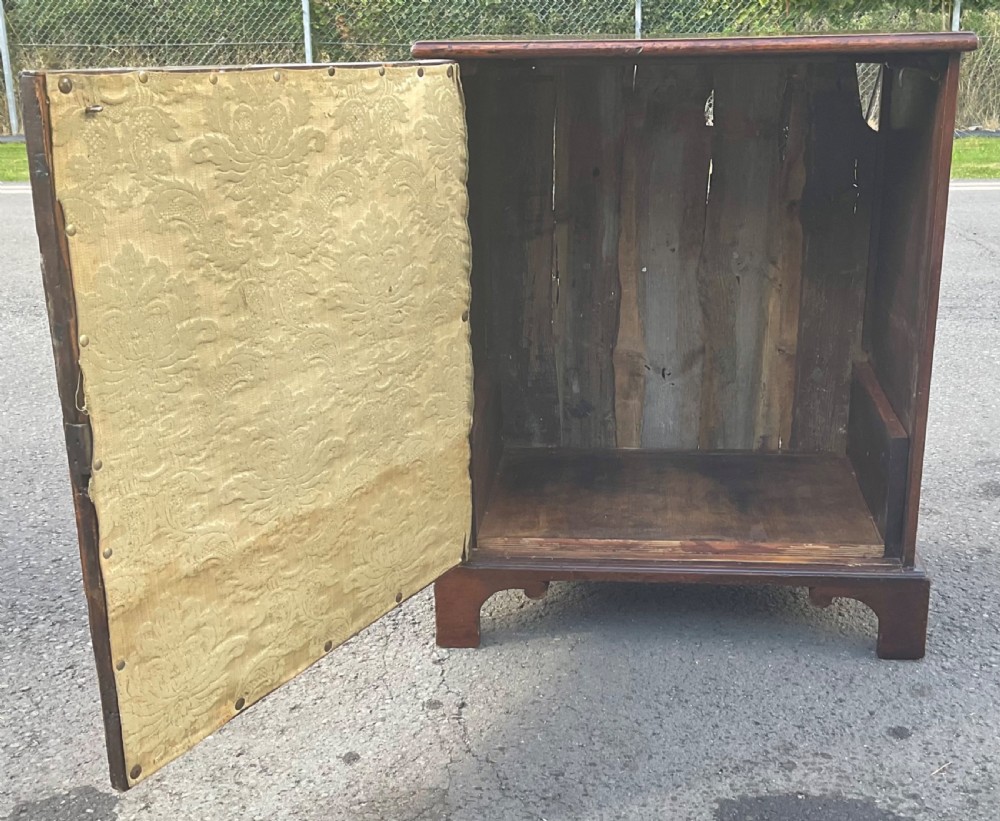 An antique Georgian mahogany side cupboard featuring pressed brass backplate handles, keyhole escutcheons, and bracket feet. View VII