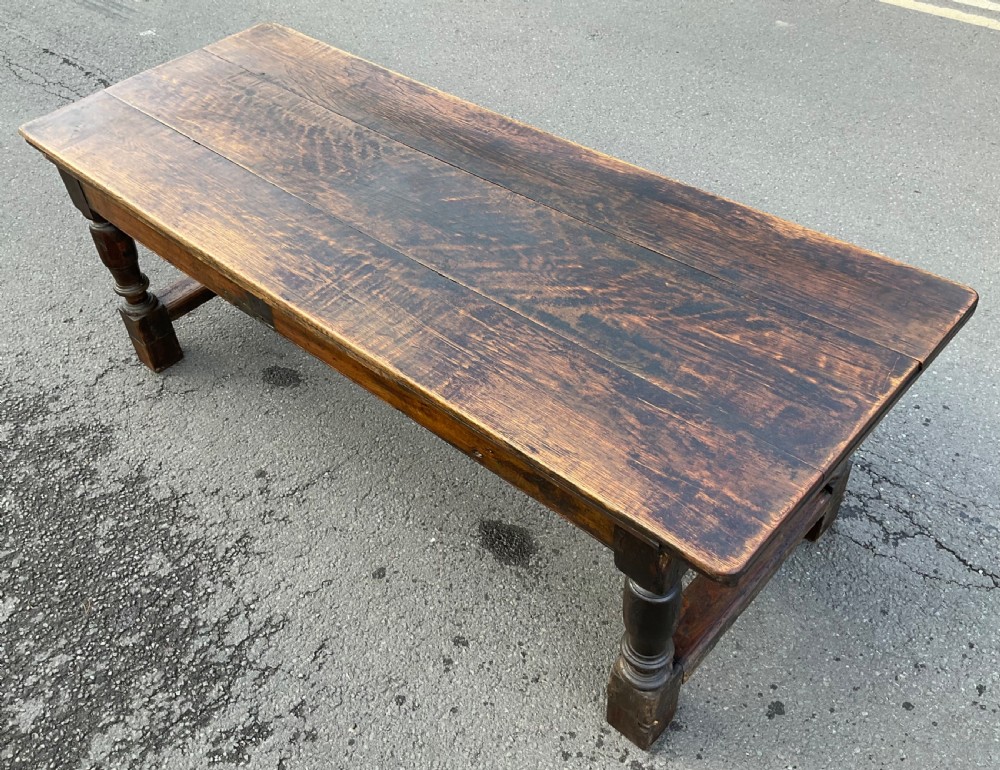 A rectangular antique oak refectory dining table featuring a thick wooden top, turned legs, and a low H-stretcher base. View XI