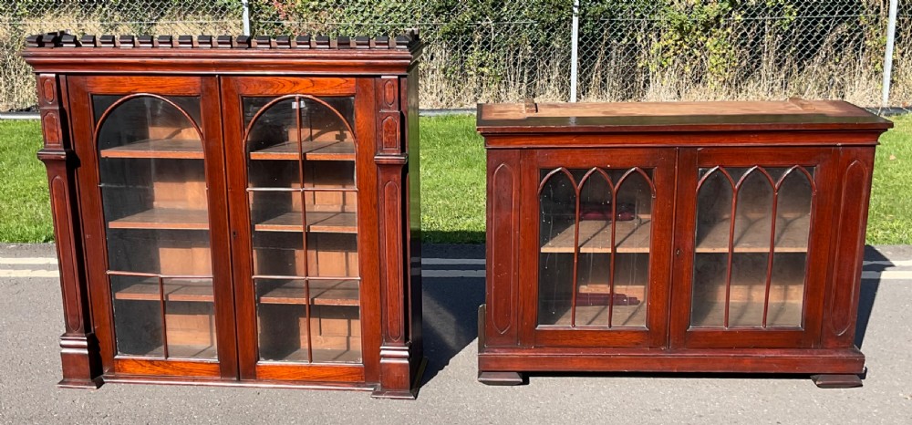 A pair of Victorian mahogany glazed library cabinets featuring Gothic arch glazing bars and adjustable interior shelves.