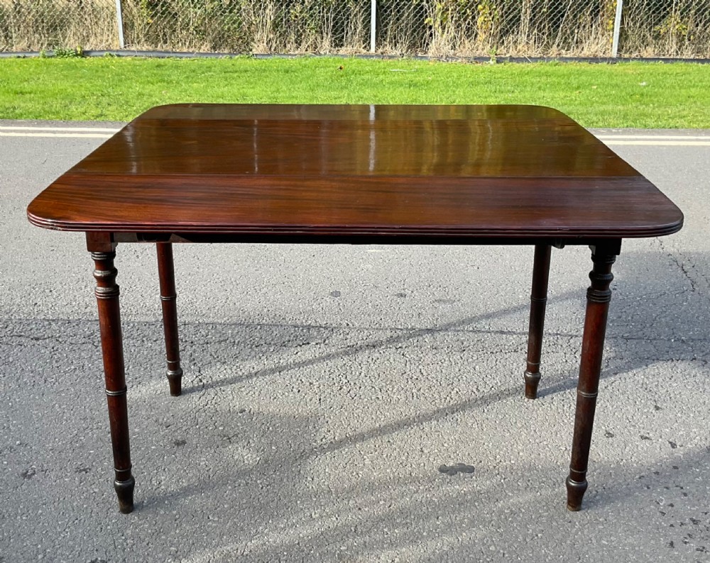 A Georgian mahogany Pembroke table featuring two drop-leaf sides, a single frieze drawer with brass handles, and four turned legs. View VIII