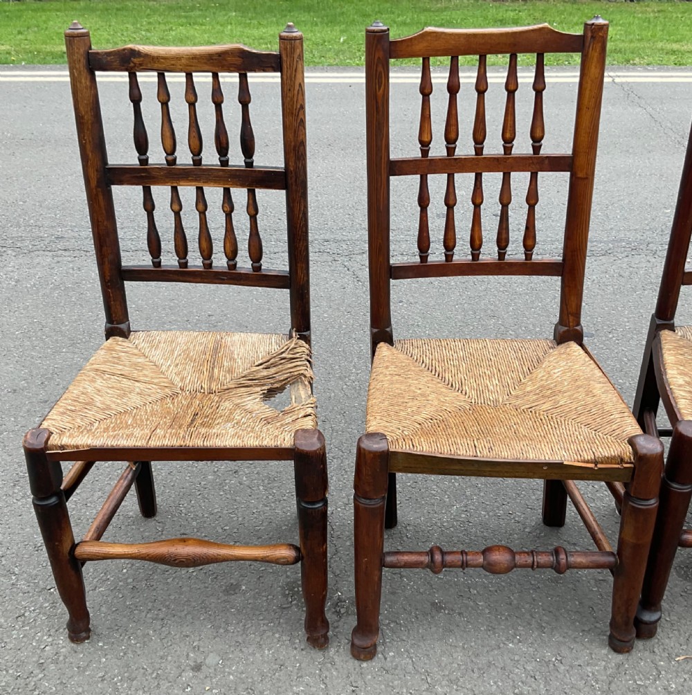 A set of five antique elm Lancashire spindleback dining chairs featuring double-tiered turned back spindles and woven rush seats. View III
