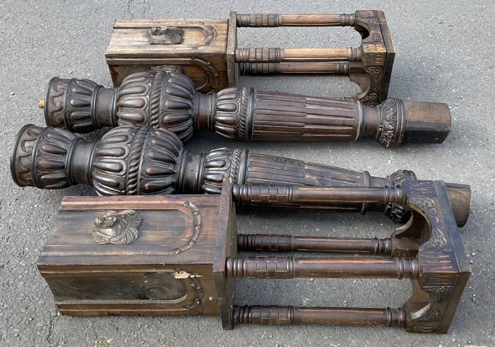 A pair of tall dark carved oak bed posts featuring gadrooned turned balusters, open arcaded sections, and square bases decorated with carved lion masks. View VIII
