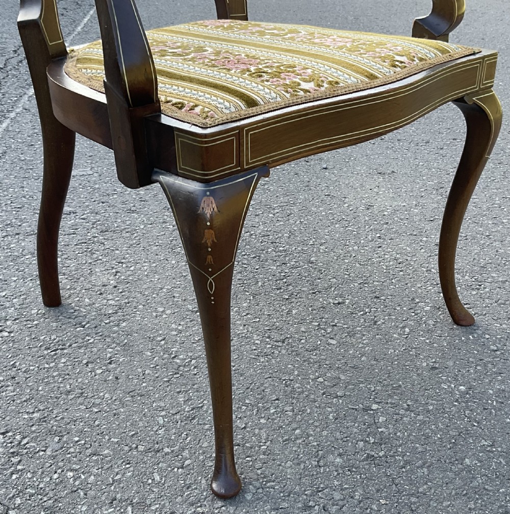 An Edwardian dark mahogany armchair with floral marquetry inlay on the splat back, cabriole front legs, and a patterned velvet upholstered seat. View XI