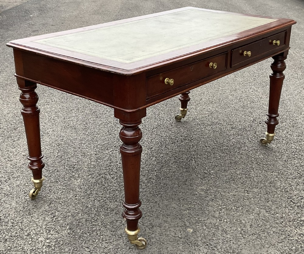A rectangular Chippendale style mahogany stool featuring cabriole legs with carved knees, ball and claw feet, and pattern-upholstered top trimmed with fringe. View II