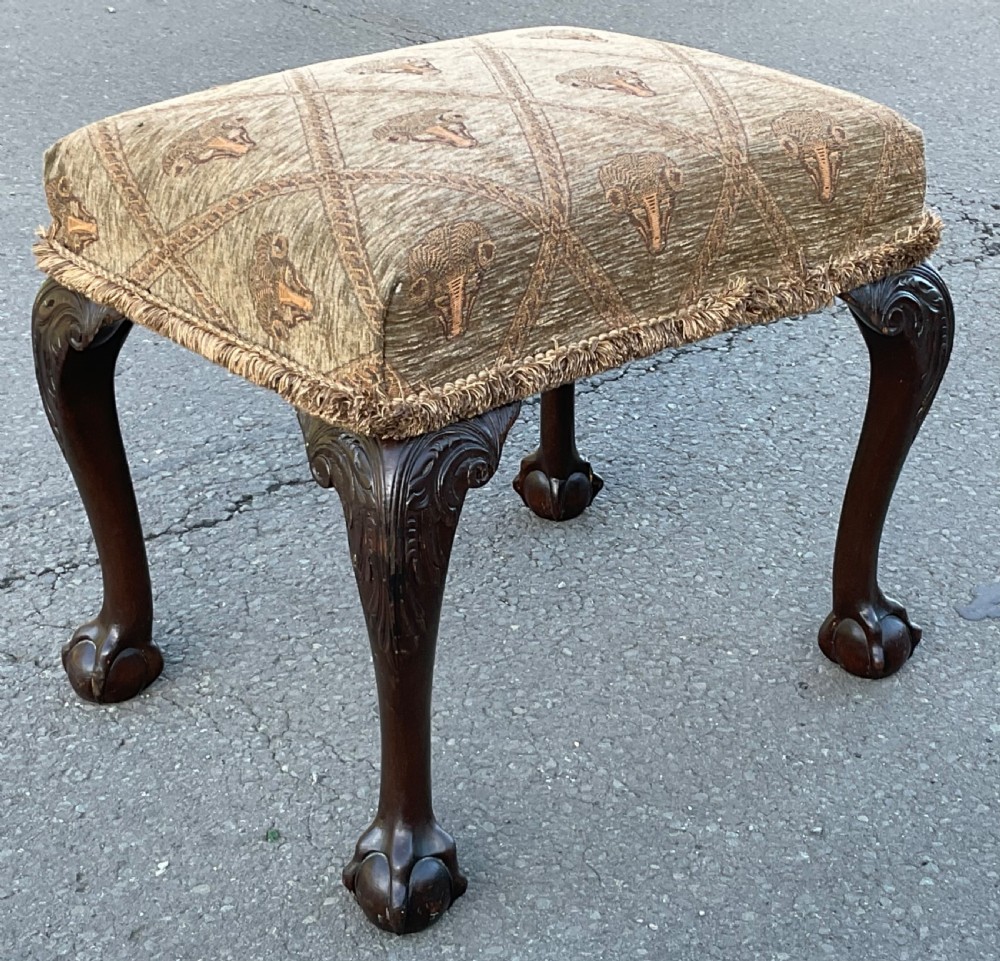 A rectangular Chippendale style mahogany stool featuring cabriole legs with carved knees, ball and claw feet, and pattern-upholstered top trimmed with fringe. View III