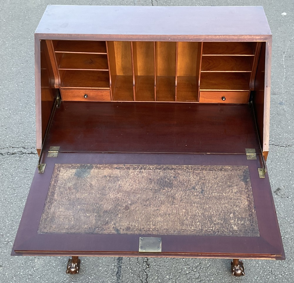 A Chippendale style mahogany writing bureau featuring a angled slant-front lid above two drawers, raised on carved cabriole legs with ball-and-claw feet. View VIII