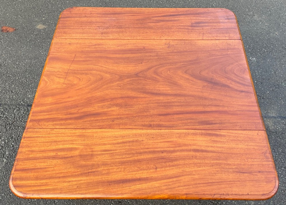 A Victorian mahogany Pembroke table featuring two drop leaves, a single frieze drawer with wooden knobs, turned reeded legs, and brass castors. View VIII