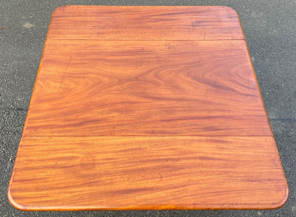 A Victorian mahogany Pembroke table featuring two drop leaves, a single frieze drawer with wooden knobs, turned reeded legs, and brass castors. View IX