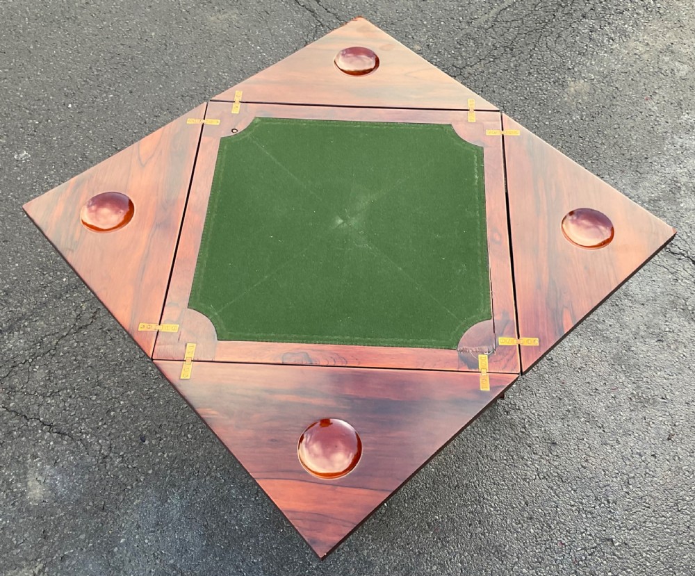 An Edwardian inlaid mahogany envelope card table featuring triangular fold-out top sections with marquetry urn motifs, a single frieze drawer, cabriole legs, and a shaped undertier. View IX
