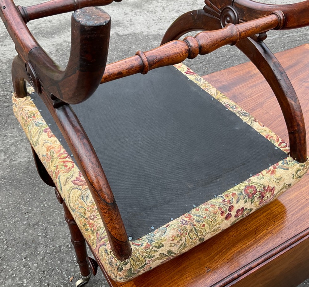 A Victorian rosewood cross-frame dressing stool featuring curved X-shaped legs, central carved rosettes, turned stretchers, and a patterned tapestry seat. View VIII