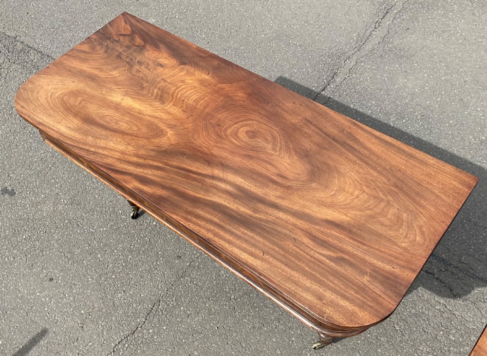 A large Regency mahogany extending dining table featuring spiral-turned legs fitted with brass castors. View XI