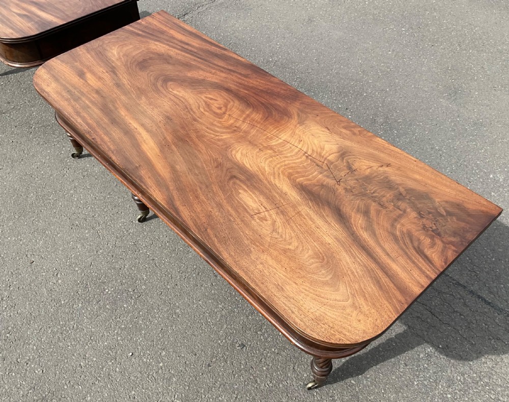 A large Regency mahogany extending dining table featuring spiral-turned legs fitted with brass castors. View XII