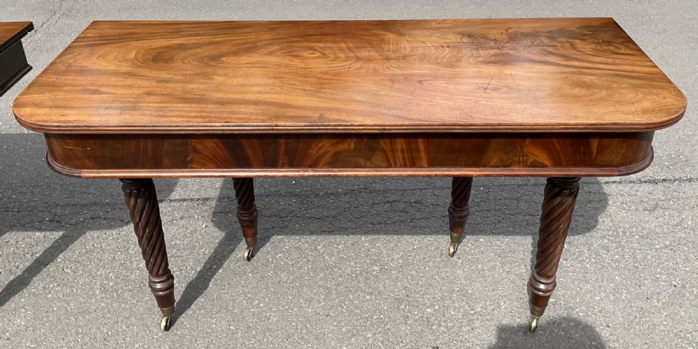 A large Regency mahogany extending dining table featuring spiral-turned legs fitted with brass castors. View XIV