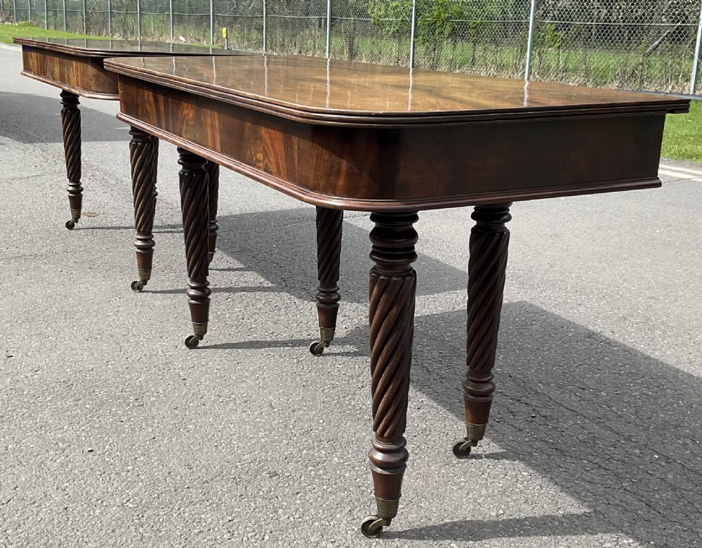 A large Regency mahogany extending dining table featuring spiral-turned legs fitted with brass castors. View XVI