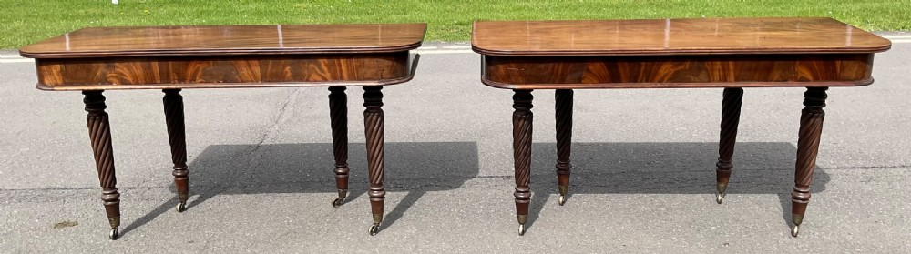 A large Regency mahogany extending dining table featuring spiral-turned legs fitted with brass castors. View XIX