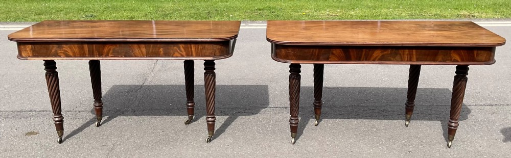 A large Regency mahogany extending dining table featuring spiral-turned legs fitted with brass castors. View XX