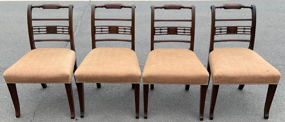 Set of six dark mahogany Georgian dining chairs featuring reeded frames, carved bar backs, and beige fabric seats. View V