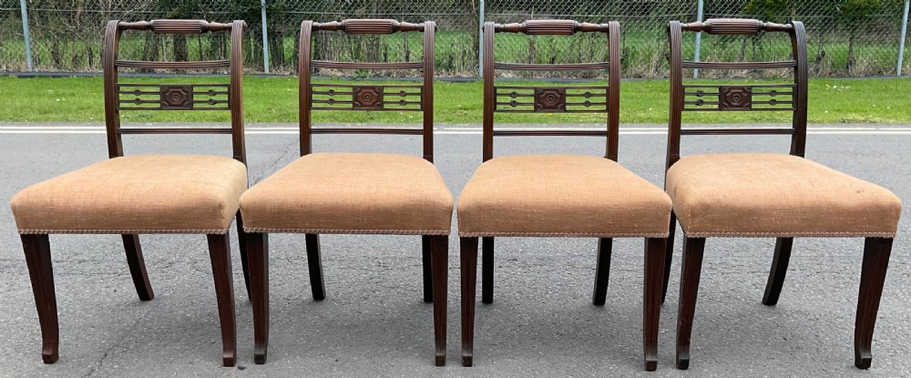 Set of six dark mahogany Georgian dining chairs featuring reeded frames, carved bar backs, and beige fabric seats. View VI
