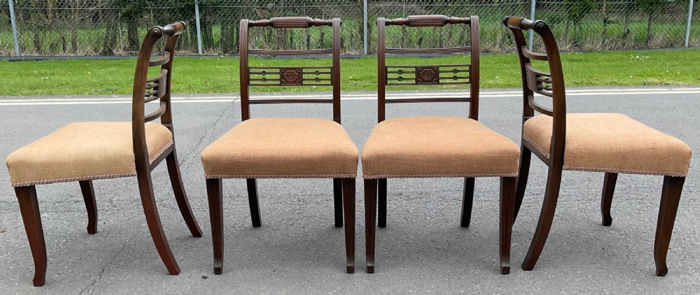 Set of six dark mahogany Georgian dining chairs featuring reeded frames, carved bar backs, and beige fabric seats. View VII