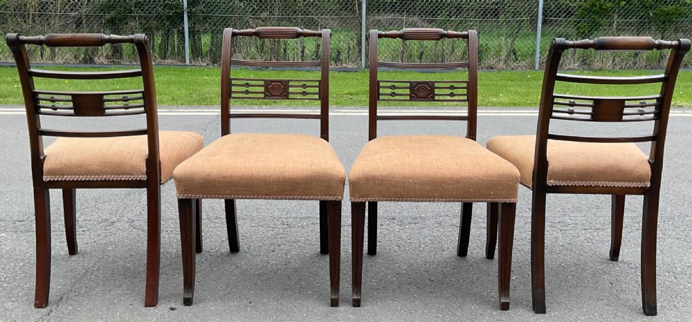Set of six dark mahogany Georgian dining chairs featuring reeded frames, carved bar backs, and beige fabric seats. View VIII