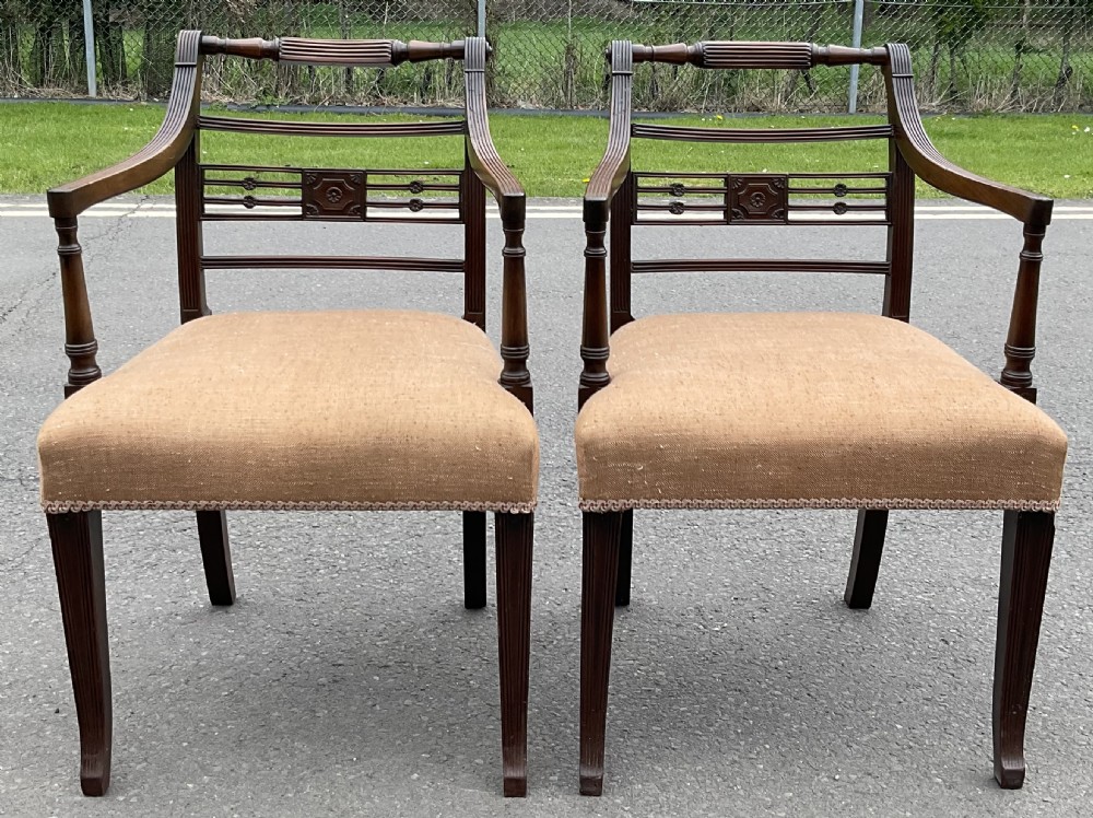 Set of six dark mahogany Georgian dining chairs featuring reeded frames, carved bar backs, and beige fabric seats. View IX