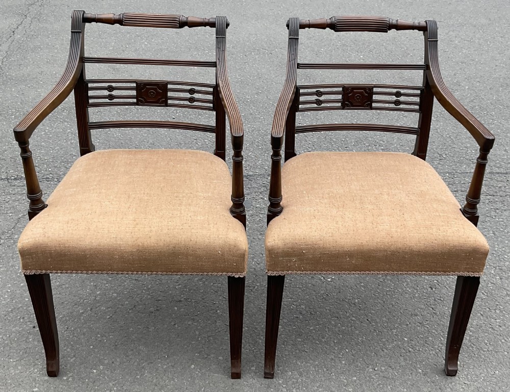 Set of six dark mahogany Georgian dining chairs featuring reeded frames, carved bar backs, and beige fabric seats. View X