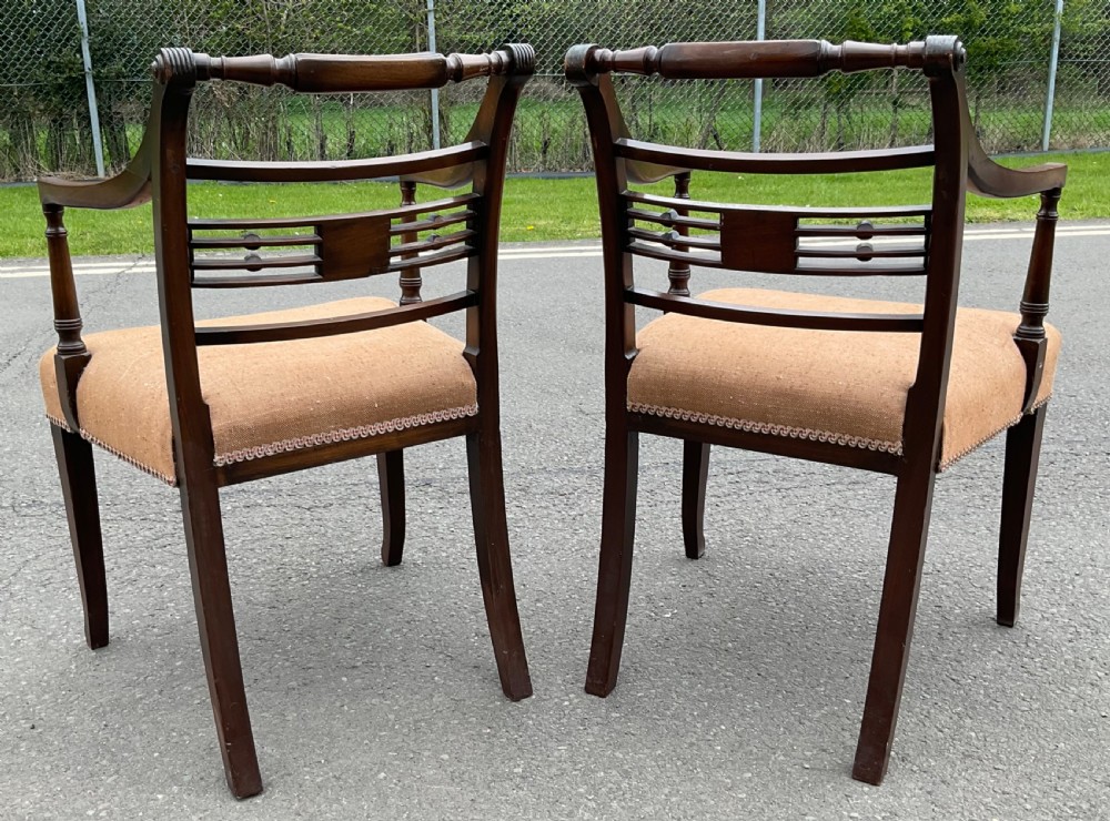 Set of six dark mahogany Georgian dining chairs featuring reeded frames, carved bar backs, and beige fabric seats. View XII