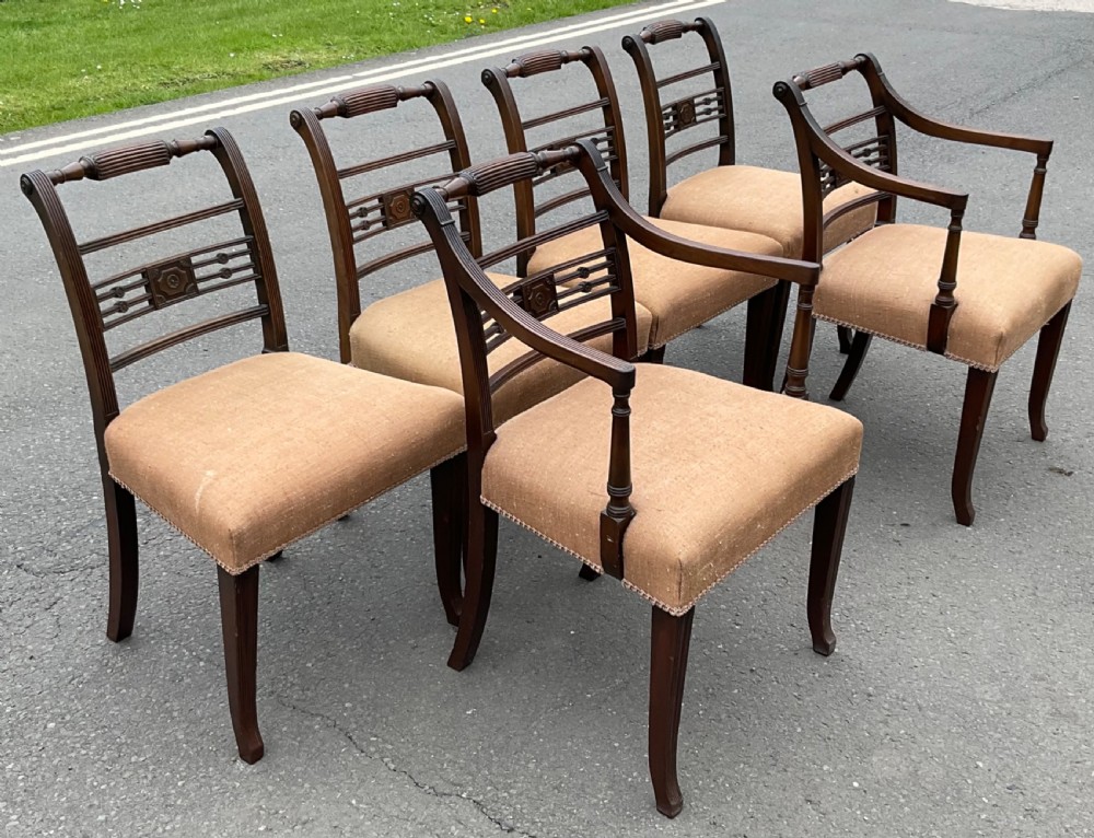 Set of six dark mahogany Georgian dining chairs featuring reeded frames, carved bar backs, and beige fabric seats. View XIII