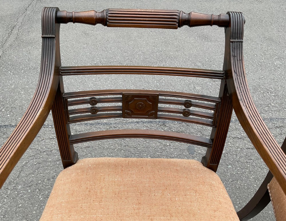 Set of six dark mahogany Georgian dining chairs featuring reeded frames, carved bar backs, and beige fabric seats. View XIV